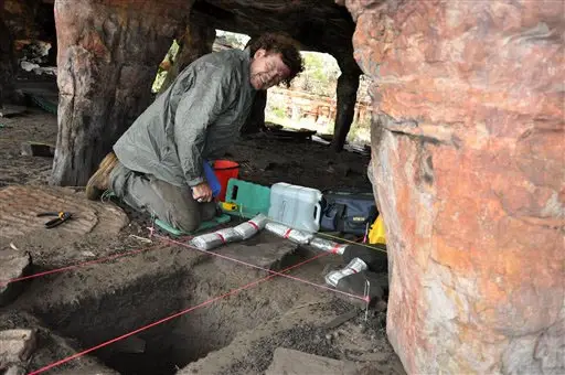 In this May 2012 photo provided by Bryce Barker, University of Southern Queensland archaeologist Bryce Barker investigates Aboriginal rock art in a cave in the Australian Outback. Prof. Barker said Monday, June 18, 2012 that tests show the Aboriginal rock art in the cave was made 28,000 years ago, making it the oldest in Australia and among the oldest in the world. (AP Photo/Bryce Barker)
