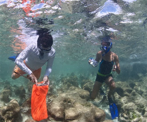 Bahamian Archaeologist Kelly Delancy documents Corey Malcolm, the Mel Fisher Maritime Heritage Society Archaeologist, recovering artefacts from the wrecked slave ship “Peter Mowell.”
