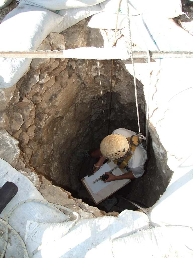 An Israel Antiquities Authority worker goes down into the well. Photographic credit: Yotam Tepper, courtesy of the Israel Antiquities Authority.