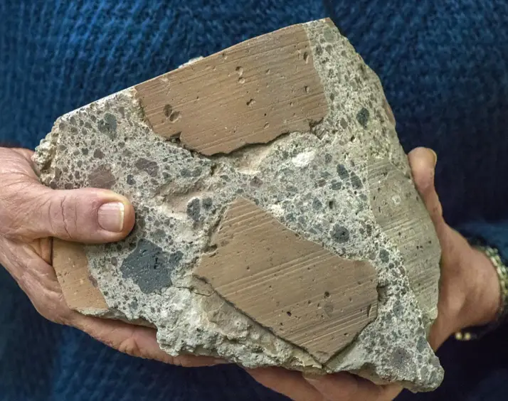 Ancient Roman concrete consists of coarse chunks of volcanic tuff and brick bound together by a volcanic ash-lime mortar that resists microcracking, a key to its longevity and endurance. Credit: (Photo by Roy Kaltschmidt, Berkeley Lab)