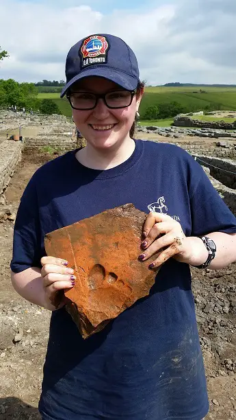 Mel Benard with tile - Vindolanda Trust