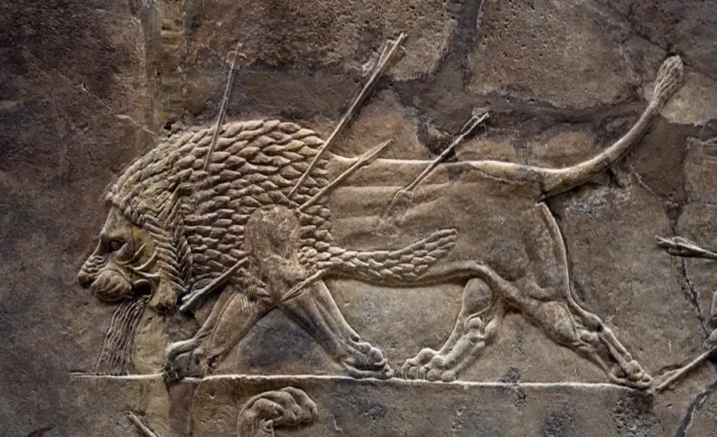 Assyrian relief from Nineveh, depicting a dying lion. Tag from exhibit says "Courtiers watching lion hunts. Assyrian, about 645-635 BC. - Credit : British Museum