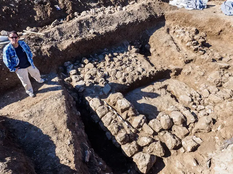 remains of chalcolithic era settlement found in jerusalem Excavation director Ronit Lupo of the Israel Antiquities Authority next to the remains of the ancient house. Copyright: Assaf Peretz, courtesy of the Israel Antiquities Authority