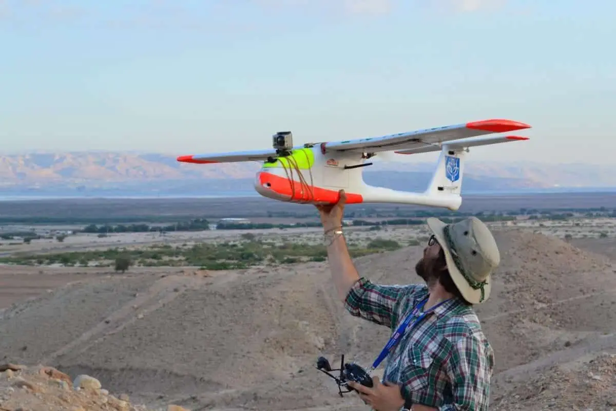 drones for research: depaul university archaeologist to explain uav use at fifa Austin "Chad" Hill, a research scientist at the University of Connecticut, prepares a fixed wing drone for a flight over the landscape at Fifa in Jordan. Hill works with archaeologist Morag M. Kersel, an assistant professor at DePaul University, using drones for site documentation and monitoring at the site with the support of the Jordanian Department of Antiquities. CREDIT Photo by Morag M. Kersel, courtesy of the Follow the Pots Project